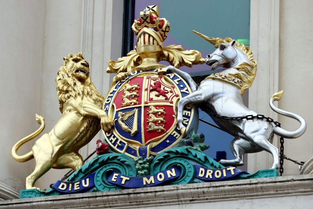Close-up of the Royal Coat of Arms featuring a lion and unicorn on a Melbourne building facade.